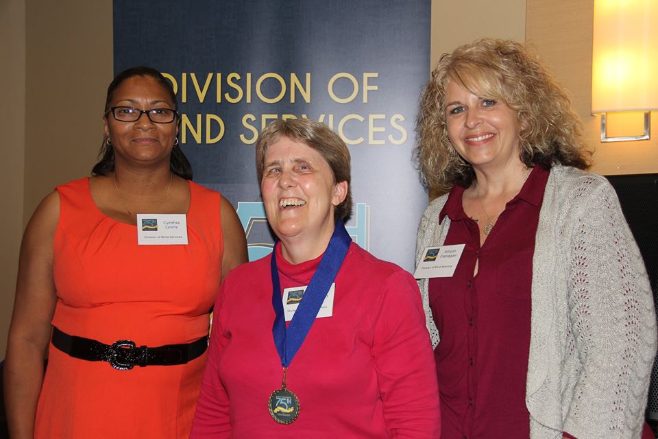 DBS Employee standing with DBS staff members Allison Flannigan and Cynthia Lyons during the Successful 75 Award presentation.